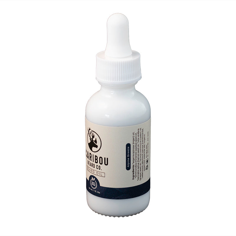 a 1oz/30ml white dropper bottle of Caribou Beard Co's Beard Oil in Alpine Breeze scent, side view.