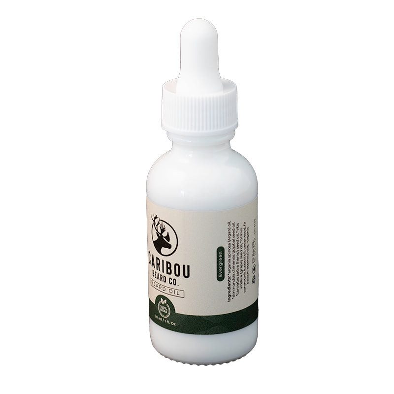 a 1oz/30ml white dropper bottle of Caribou Beard Co's Beard Oil in Evergreen scent, side view. 
